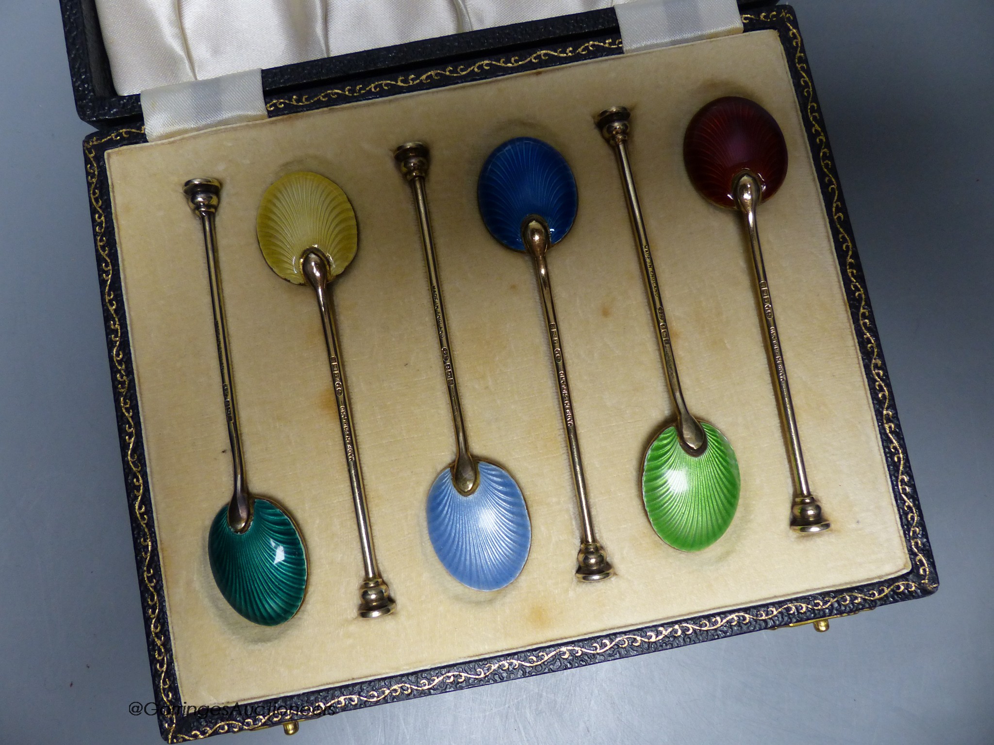 A cased set of six silver gilt and enamel coffee spoons, Birmingham, 1954.